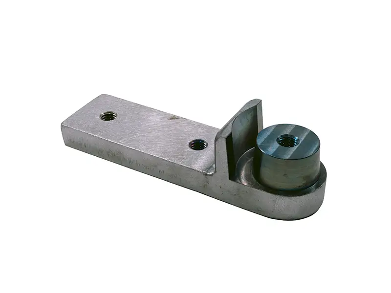 Anschlussstück komplett (29264) mit Metallwinkel, rechteckigem Fuß, zwei Schraubenlöchern und zylindrischem Knopf für die Arbeitssicherheit.